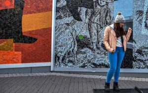 Rizwana posing by mural